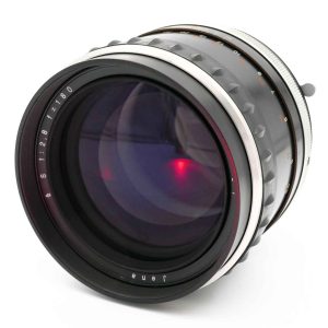 Dieses Jena S 2.8/ 180 Objektiv (6883997 entspricht dem Carl Zeiss Jena Objektiv. Bei den Zusatzinformationen unten lesen Sie wieso auf der Optik nur Jena eingraviert wurde. Das Jena 180mm wurde revidiert und ist in einem sehr guten Zustand. Die Linsen sind klar und ohne Kratzer oder Vergütungsschäden. Die Blendenlamellen wurden gereinigt, die Mechanik schliesst die Blende schnell. Auf dem Tubus und dem Objektivbajonett sieht man nur wenig Gebrauchsspuren. Der Scharfeinstellring dreht satt. von clean-cameras